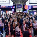 Thousands of digital marketing professionals walking the busy expo floor at DMEXCO 2026 inside Koelnmesse, Cologne, Germany