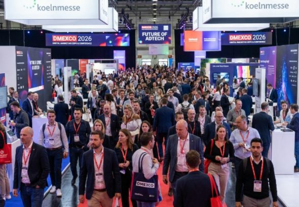 Thousands of digital marketing professionals walking the busy expo floor at DMEXCO 2026 inside Koelnmesse, Cologne, Germany