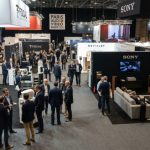 Exhibitor booths showcasing hi-fi speakers and home cinema systems on the show floor at the Paris Audio Video Show 2026 in the Palais des Congrès de Paris
