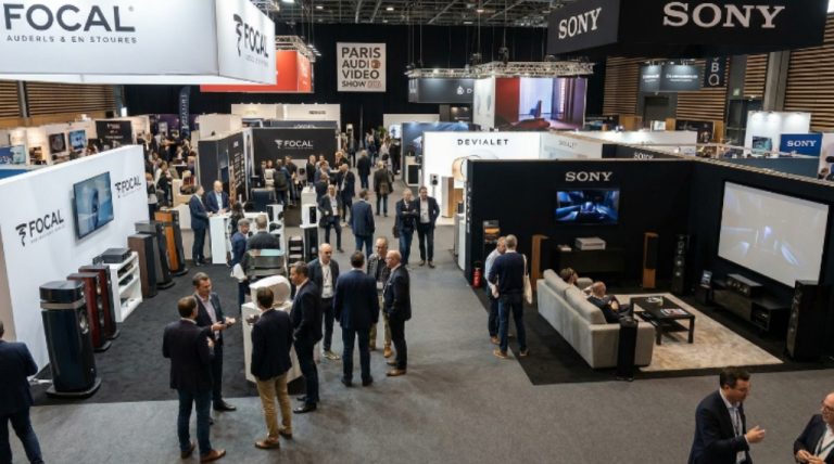 Exhibitor booths showcasing hi-fi speakers and home cinema systems on the show floor at the Paris Audio Video Show 2026 in the Palais des Congrès de Paris