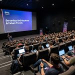 Developers and cloud engineers attending a technical session inside the Multikino Złote Tarasy cinema auditorium at AWS Community Day Poland 2026 in Warsaw