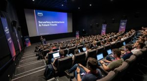 Developers and cloud engineers attending a technical session inside the Multikino Złote Tarasy cinema auditorium at AWS Community Day Poland 2026 in Warsaw