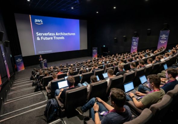 Developers and cloud engineers attending a technical session inside the Multikino Złote Tarasy cinema auditorium at AWS Community Day Poland 2026 in Warsaw